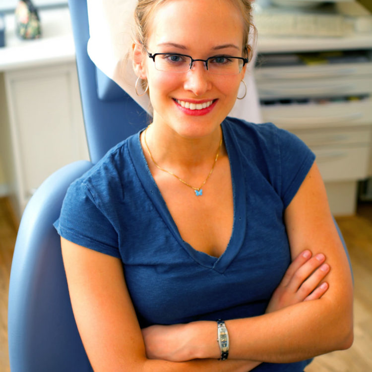 girl sitting in chair with arms crossed